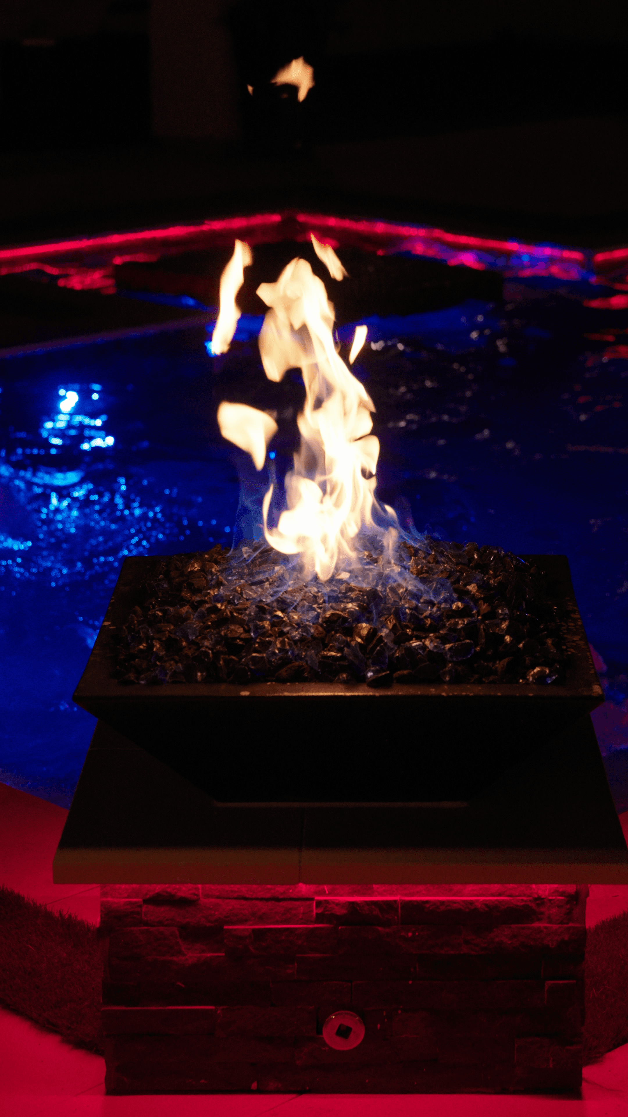 Illuminated pool and spa at night